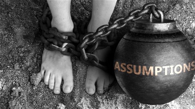 Assumptions as a negative aspect of life - symbolized by word Assumptions and and chains to show burden and bad influence of Assumptions, 3d illustration