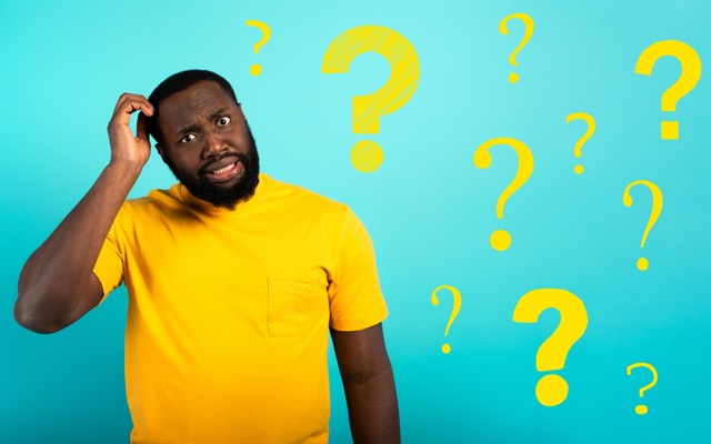 Confused and pensive expression of a black boy with many questions . cyan colored background