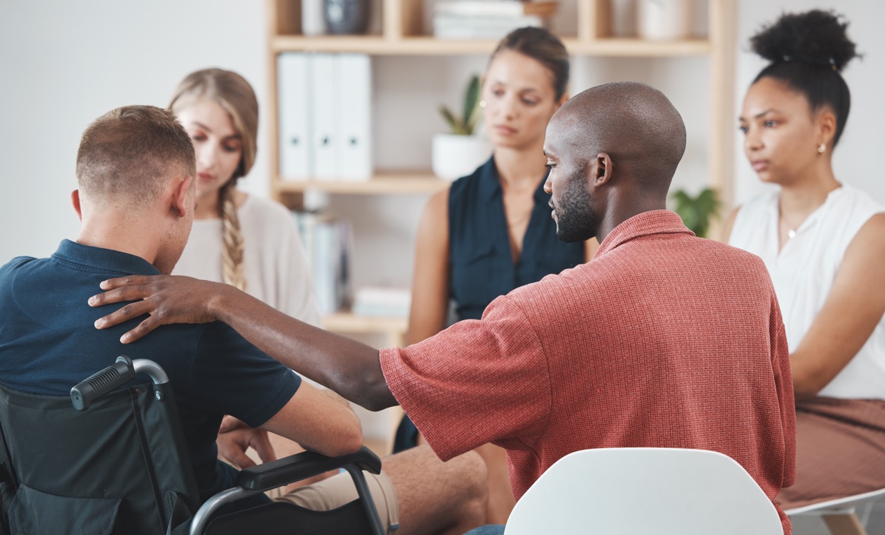 Group counseling, mental health therapy and anxiety wellness conversation for problem of a disabled man. Community support, empathy and compassion for employee burnout or stress in a business office.