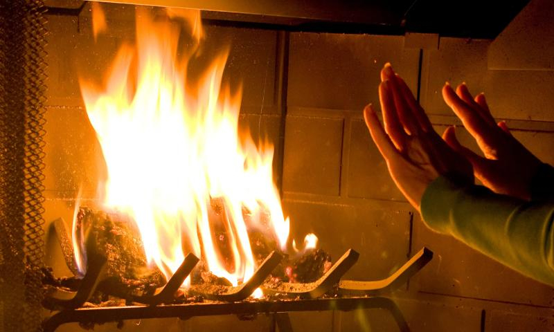 a woman warming her hands