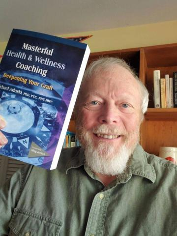 Michael Arloski, Ph.D., PCC, CWP, NBC-HWC book in hand