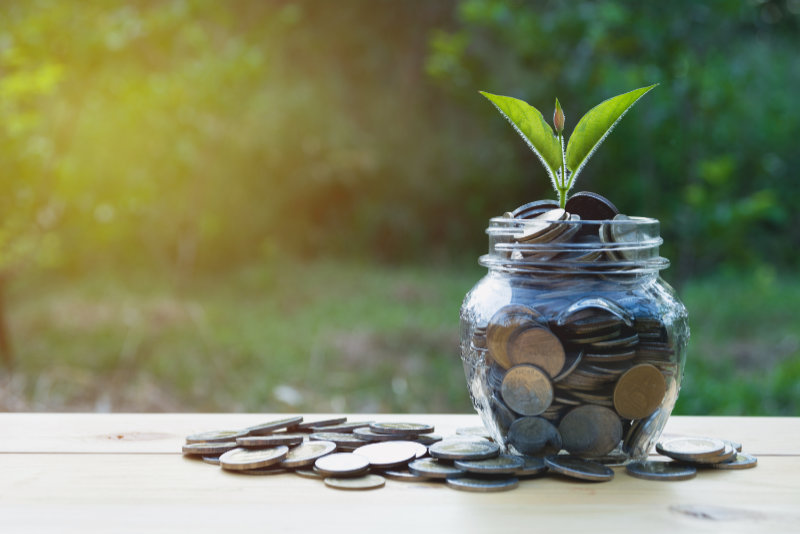 Coins in jar with money stack step growing money, Concept finance business and saving investment.