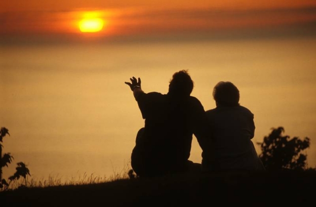 people on beach at sunset