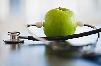 green apple wrapped around stethoscope