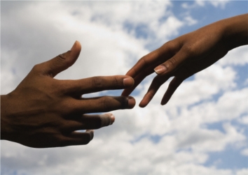 hands of couple reaching for each other resize