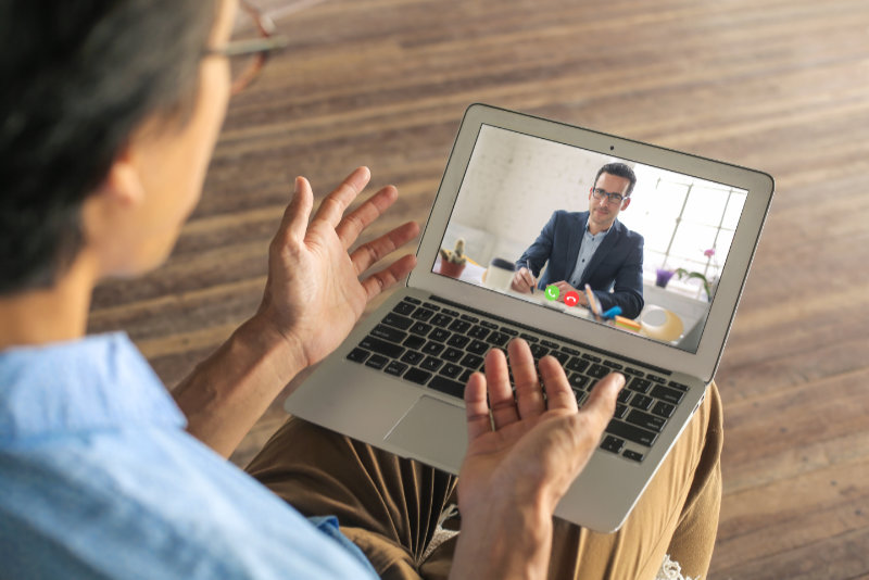 Man applying for a remote work. He is doing his interview on a video call.