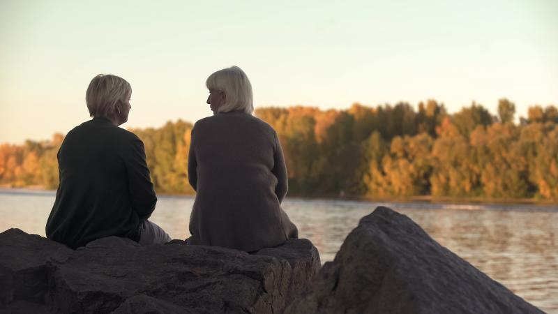 women on river rock